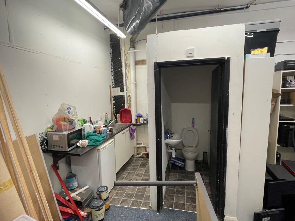 Lot: 18 - COMMERCIAL UNIT ON LONG LEASE FOR INVESTMENT - Kitchen aea and toilet